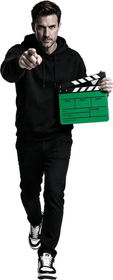 Man pointing at camera holding a green clapperboard for a content creation company